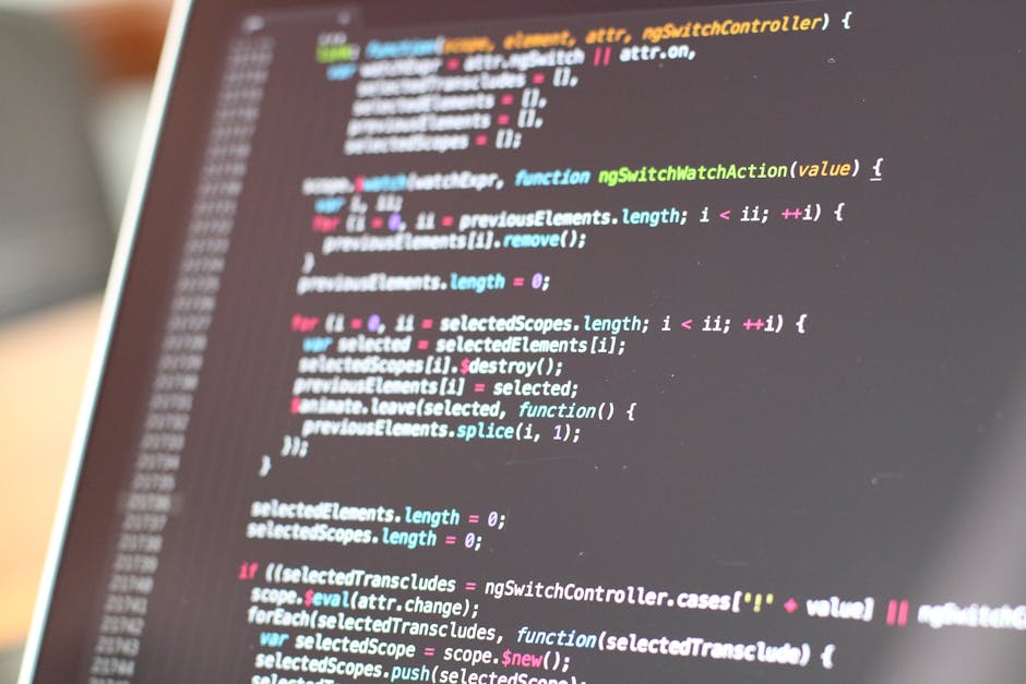 A close-up view of a computer screen displaying lines of colorful code, including syntax highlighted JavaScript or similar programming language. The code features functions, variables, and control str